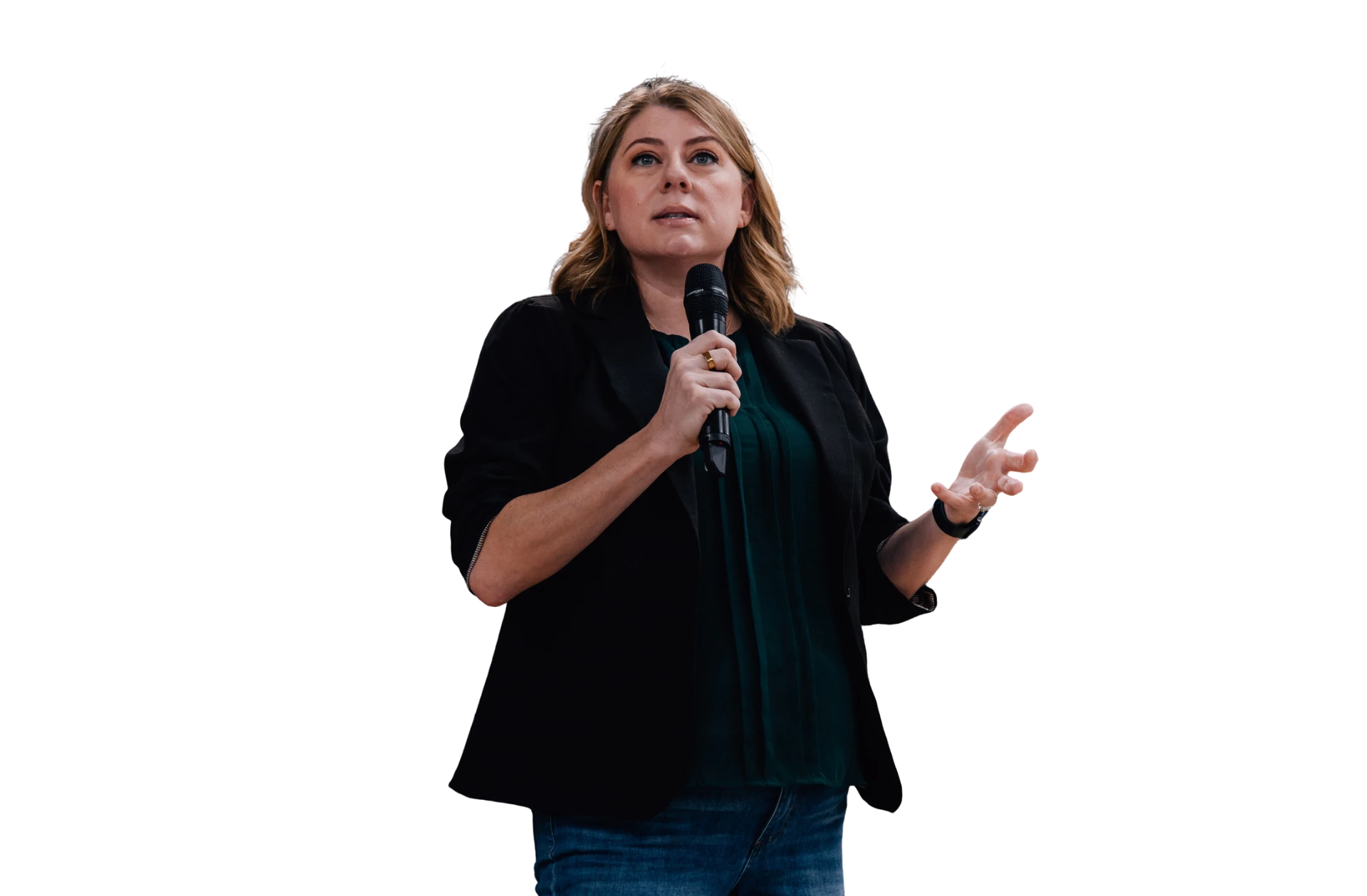 Lynda speaking on stage, holding a microphone
